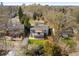 Aerial view of home featuring a large deck, green lawn, mature trees and landscaping at 1180 S Honey Way, Denver, CO 80224