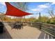 Spacious back deck with a dining area, shade cover, and outdoor grill, perfect for entertaining at 1180 S Honey Way, Denver, CO 80224