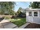 Spacious backyard with a shed, beautiful green lawn, and mature trees, perfect for outdoor enjoyment at 1180 S Honey Way, Denver, CO 80224