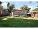 Spacious backyard with lush green lawn and a charming deck for outdoor living at 1180 S Honey Way, Denver, CO 80224