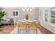 Inviting dining area with seating for six, a modern light fixture, and stylish décor at 1180 S Honey Way, Denver, CO 80224