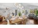 Elegant dining area featuring a modern chandelier, hardwood floors, and an open view to the living room at 1180 S Honey Way, Denver, CO 80224