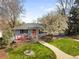 Charming home featuring a landscaped front yard with a beautiful walkway and vibrant red accents at 1180 S Honey Way, Denver, CO 80224