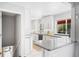 Bright, updated kitchen featuring white cabinets, modern countertops, and stainless steel appliances at 1180 S Honey Way, Denver, CO 80224