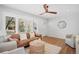 Comfortable living room with hardwood floors, a stylish ceiling fan, and ample natural light at 1180 S Honey Way, Denver, CO 80224