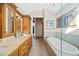 Bright bathroom featuring a soaking tub and wood vanity with dual sinks and plenty of counter space at 229 Albion St, Denver, CO 80220