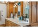 Bathroom with a spacious vanity, dual sinks, and beautiful wood cabinets, offering ample storage at 229 Albion St, Denver, CO 80220