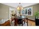 Dining room with hardwood floors, statement chandelier and a large window at 229 Albion St, Denver, CO 80220