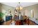 Dining room with hardwood floors, statement chandelier and views of the kitchen at 229 Albion St, Denver, CO 80220