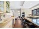 Bright kitchen with stainless steel appliances, eat-in island, and tile countertops at 229 Albion St, Denver, CO 80220