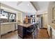 Bright kitchen featuring stainless steel appliances, a large island, and hardwood floors at 229 Albion St, Denver, CO 80220