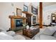 Bright living room features a wooden fireplace, trunk coffee table, and unique architectural details at 229 Albion St, Denver, CO 80220
