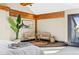 Bright, airy main bedroom features comfortable seating area, hardwood beams, and natural light at 229 Albion St, Denver, CO 80220