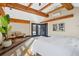 Bright main bedroom with vaulted ceilings, wood beams, and patio access at 229 Albion St, Denver, CO 80220