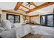 Bright main bedroom boasting exposed wood beams, comfortable seating area, and light-filled windows at 229 Albion St, Denver, CO 80220