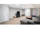 Finished basement area featuring neutral colors, comfortable seating, and ample lighting at 6676 S Kit Carson St, Centennial, CO 80121