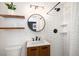 Modern bathroom featuring sleek fixtures, subway tile, and floating shelves, offering a stylish and functional space at 6676 S Kit Carson St, Centennial, CO 80121