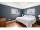 Serene bedroom with hardwood floors, neutral walls, and natural light, creating a relaxing retreat at 6676 S Kit Carson St, Centennial, CO 80121