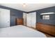 Calm bedroom featuring wood flooring, closet, and an ensuite bathroom with a door for added privacy and convenience at 6676 S Kit Carson St, Centennial, CO 80121