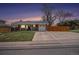 Charming single-story home featuring a well-manicured lawn, covered porch, and attached garage at 6676 S Kit Carson St, Centennial, CO 80121