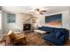 Cozy living room featuring a brick fireplace, a comfortable sofa, and stylish decor, perfect for relaxation at 6676 S Kit Carson St, Centennial, CO 80121