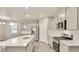 Modern kitchen with stainless steel appliances, a large island, and sleek white cabinets at 1144 Ridgefield Dr, Berthoud, CO 80513