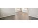 Bright open-concept living room and kitchen features stylish wood floors and fresh paint at 1144 Ridgefield Dr, Berthoud, CO 80513
