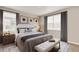 Bright and airy bedroom with large windows, neutral tones, and elegant furnishings at 1144 Ridgefield Dr, Berthoud, CO 80513