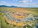 Aerial view of a Primary planned community with mountain views and lush landscaping at 16272 W 95Th Ln, Arvada, CO 80007