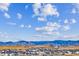 Picturesque aerial view shows the community nestled against the backdrop of rolling mountains at 16272 W 95Th Ln, Arvada, CO 80007