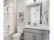Well-lit bathroom featuring a shower, vanity, and decorative wall art at 16272 W 95Th Ln, Arvada, CO 80007