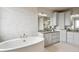 Elegant bathroom featuring a large free-standing tub and granite countertops at 16272 W 95Th Ln, Arvada, CO 80007