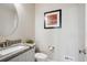 Neutral powder room featuring an oval mirror, stylish countertop, and a modern toilet at 16272 W 95Th Ln, Arvada, CO 80007