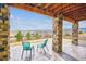 Scenic covered patio with comfortable seating and stunning views of the landscape at 16272 W 95Th Ln, Arvada, CO 80007