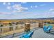 Outdoor deck area with seating and a scenic overlook of the surrounding landscape at 16272 W 95Th Ln, Arvada, CO 80007