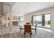 Open-concept dining area with a modern table and chairs next to large glass doors to the patio at 16272 W 95Th Ln, Arvada, CO 80007