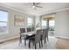 Contemporary dining area with stylish seating, neutral decor, and sliding door access to the deck at 16272 W 95Th Ln, Arvada, CO 80007