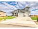 Two-story home with three-car garage and landscaped yard at 16272 W 95Th Ln, Arvada, CO 80007