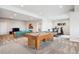 Spacious game room featuring a pool table, comfortable seating, and an exercise area at 16272 W 95Th Ln, Arvada, CO 80007