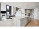 Open concept kitchen with a center island, stainless steel appliances, and seamless flow to the living area at 16272 W 95Th Ln, Arvada, CO 80007