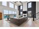 Spacious living room with soaring ceilings, large windows, a fireplace, and luxurious furnishings at 16272 W 95Th Ln, Arvada, CO 80007