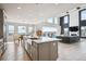 Expansive living space featuring a modern kitchen, dining area, and cozy living room with a fireplace at 16272 W 95Th Ln, Arvada, CO 80007