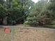 Backyard enclosed by chain link fence with an address sign at 4209 Perry St, Denver, CO 80212