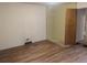 Bedroom featuring hardwood floors, a closet, and access to adjoining rooms at 4209 Perry St, Denver, CO 80212