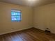 Cozy bedroom with hardwood flooring and a window providing natural light at 4209 Perry St, Denver, CO 80212