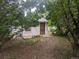 Charming cottage-style home with a textured exterior, classic wood door, and a surrounding of lush greenery at 4209 Perry St, Denver, CO 80212