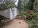 Exterior of a garage with a concrete patio, some steps, and many trees at 4209 Perry St, Denver, CO 80212