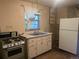 Retro kitchen featuring a vintage gas range, double basin sink, and a standard size refrigerator at 4209 Perry St, Denver, CO 80212
