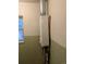 Utility area featuring a tankless water heater with a small window for ventilation at 4209 Perry St, Denver, CO 80212