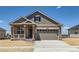 Charming single-Gathering home showcasing a welcoming porch and a spacious two-car garage in a suburban neighborhood at 5165 N Quemoy St, Aurora, CO 80019